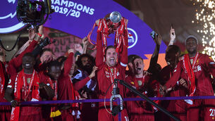 <p>AT LONG LAST: Liverpool captain Jordan Henderson lifts the Premier League trophy after last night’s victory over Chelsea at Anfield. Picture: Laurence Griffiths/NMC Pool/PA </p>