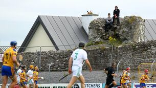 <p>THE HIGH GROUND: Fans find a vantage point to follow the action from outside the ground in Sunday’s Galway SHC clash between Sarsfields and Portumna at Kenny Park, Athenry. Sarsfields won 4-22 to 0-18.	<span class="contextmenu emphasis CaptionCredit">Picture: Inpho/James Crombie</span></p>
