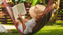 Attractive sexy woman reading book in hammock.