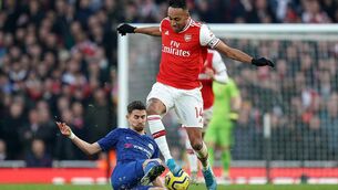 Chelsea's Jorginho and Pierre-Emerick Aubameyang of Arsenal battle for the ball at the Emirates Stadium.