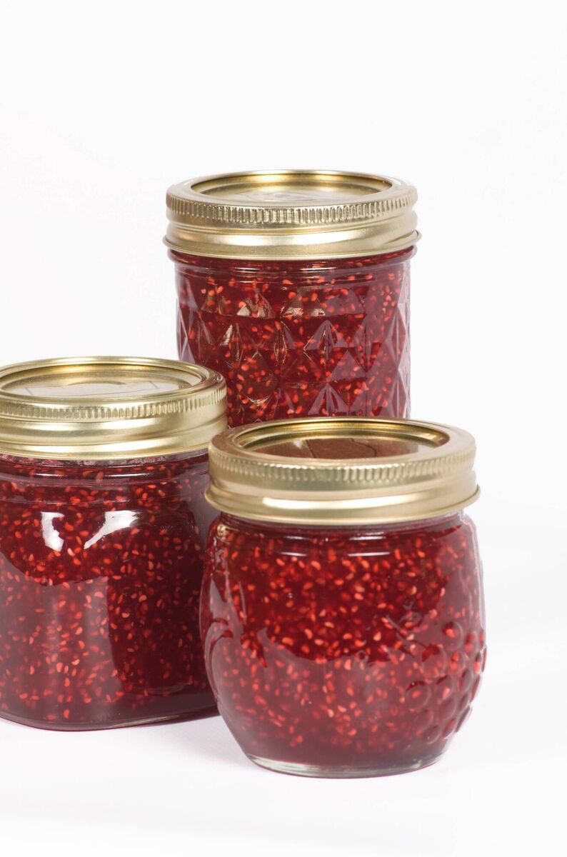 Three jars of homemade raspberry jam.