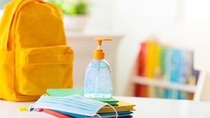 Backpack of school child with face mask and sanitizer. 