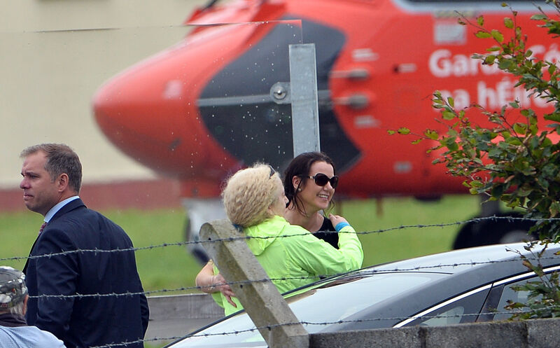 Two women embrace each other after the Coast Guard helicopter lands UCHG with the two women rescued from the sea. Picture: Ray Ryan Two women embrace each other after the Coast Guard helicopter lands UCHG with the two women rescued from the sea. Picture: Ray Ryan