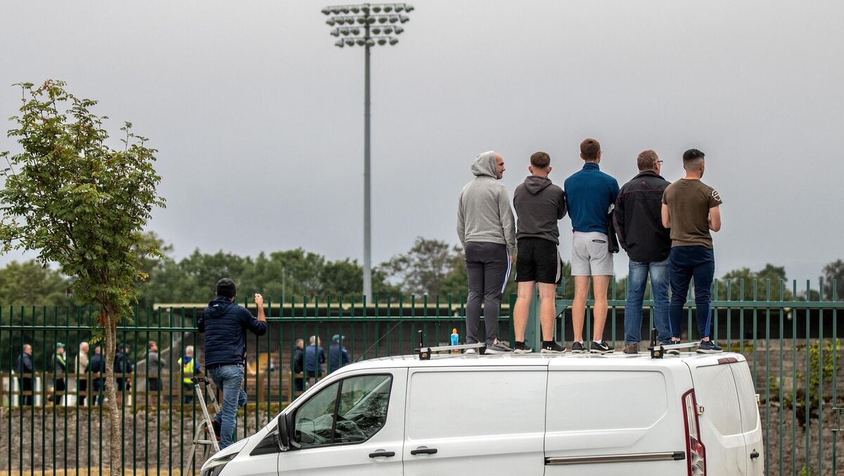 Fans look on from outside the ground