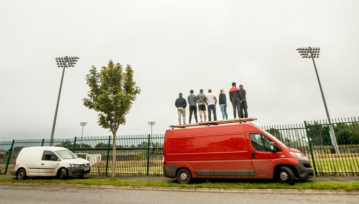 Fans look on from outside the ground