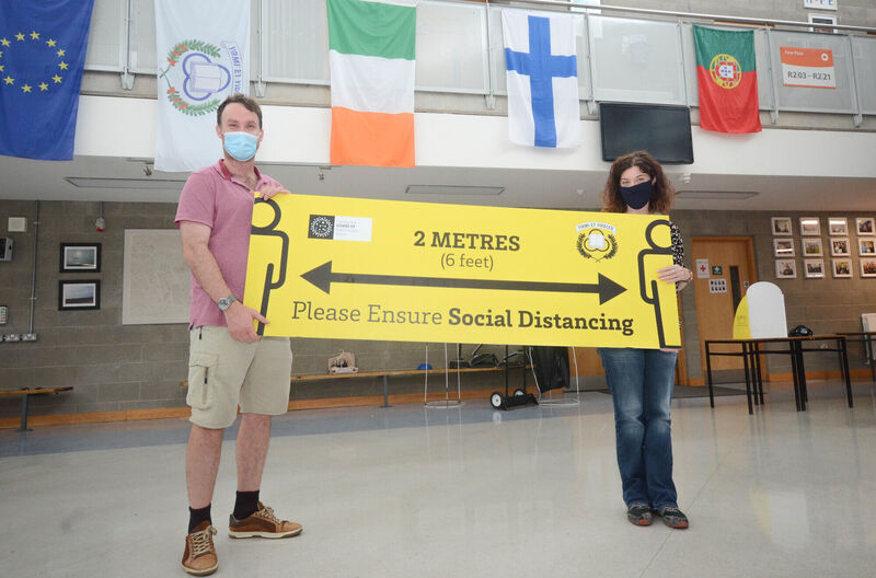 Teachers Tim O'Regan and Lorna Daly ensuring safe distancing and mask compliance as they prepare for the opening of Pobalscoil na Tríonóide in Youghal next week. Picture: Howard Crowdy
