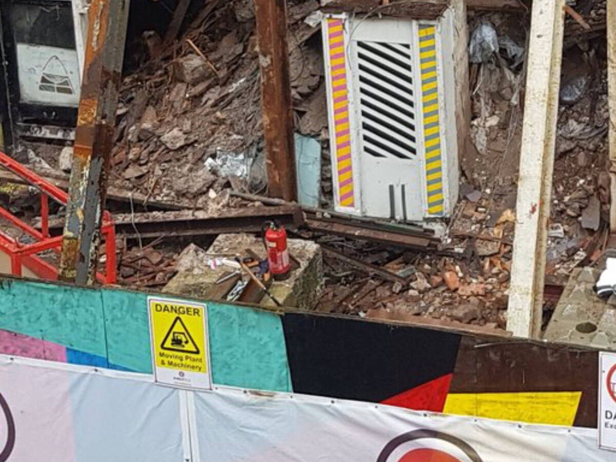 Derelict building facade is pinned in position behind hoarding on North Main Street, Cork.