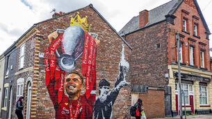 A new mural of Liverpool captain Jordan Henderson lifting the Premier League trophy and former captain Alan Hansen lifting the league trophy by artist Paul Curtis on the gable end of a house on Old Barn Road in Anfield. The champions kick off the new campaign at home to Leeds utd.