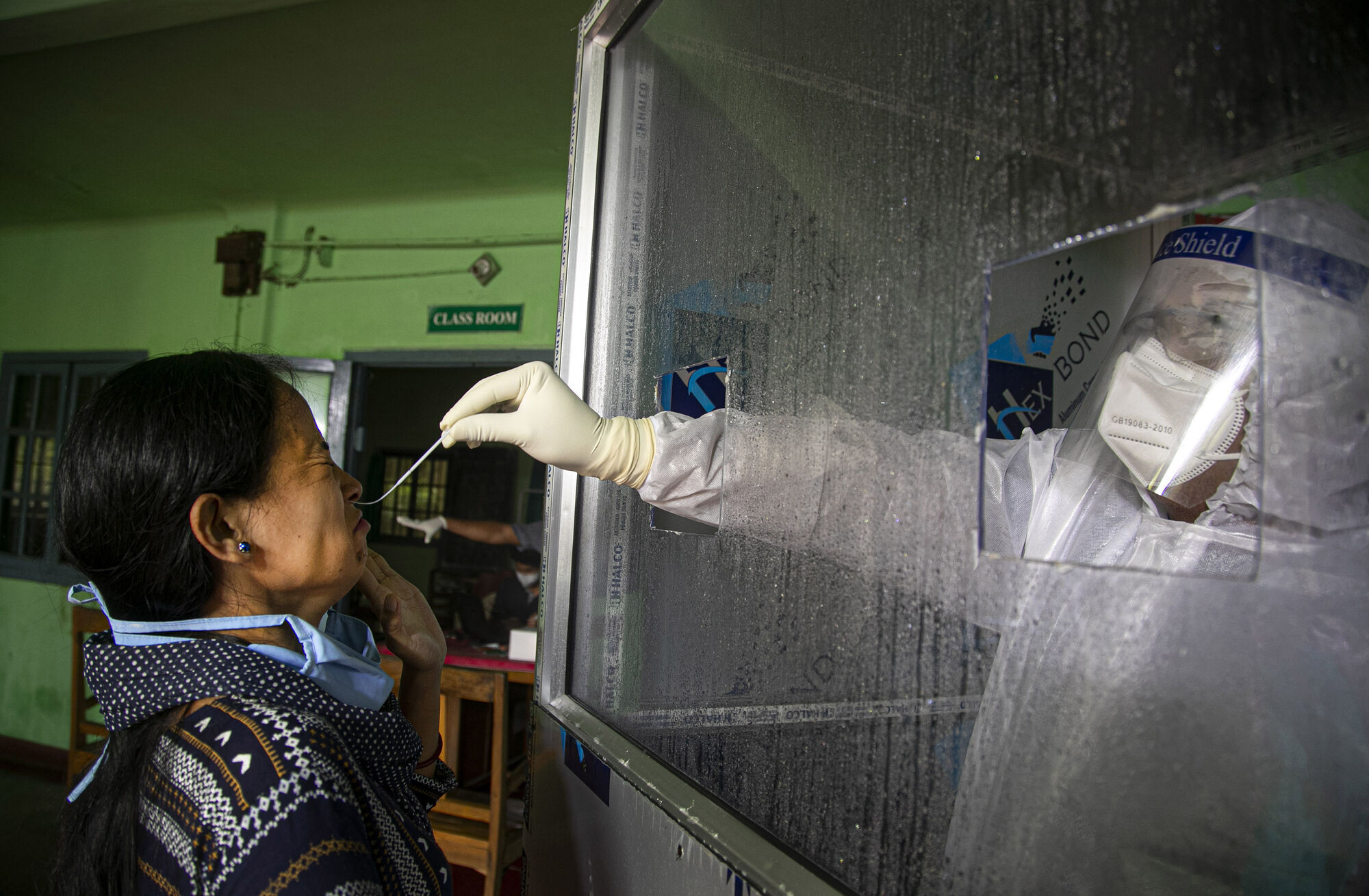 An Indian health worker takes a nasal swab sample to test for Covid-19 in Gauhati, India. Many people who have developed the disease around the world have had a long road to recovery. 	Picture: AP Photo/Anupam Nath