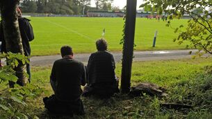Some eager supporters find a view of the Mayo County Senior Football Championship Group 4 Round 3 match between Castlebar Mitchels and Westport at Breaffy GAA Club, Co.Mayo. Photo Conor McKeown.