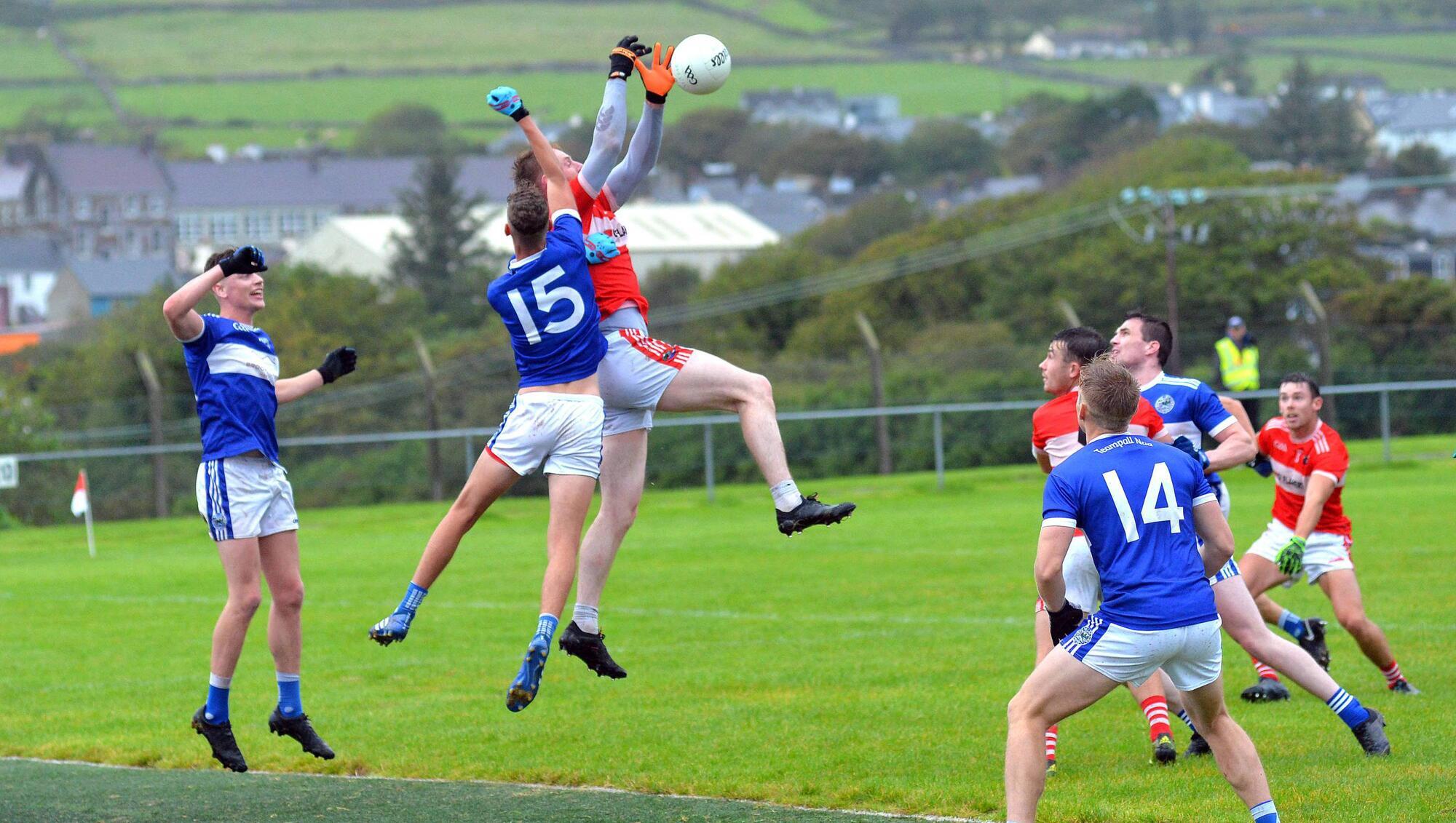 Billy O'Connor (Dingle) rises highest to this dropping ball under pressure from Templenoe's Colin Crowley. Picture: Declan Malone