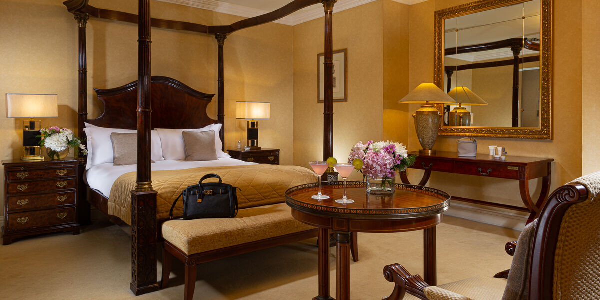 The deluxe room's hues of chocolate and mahogany create a palette of warmth while touches like period wall prints lend the air of a stately country pile.