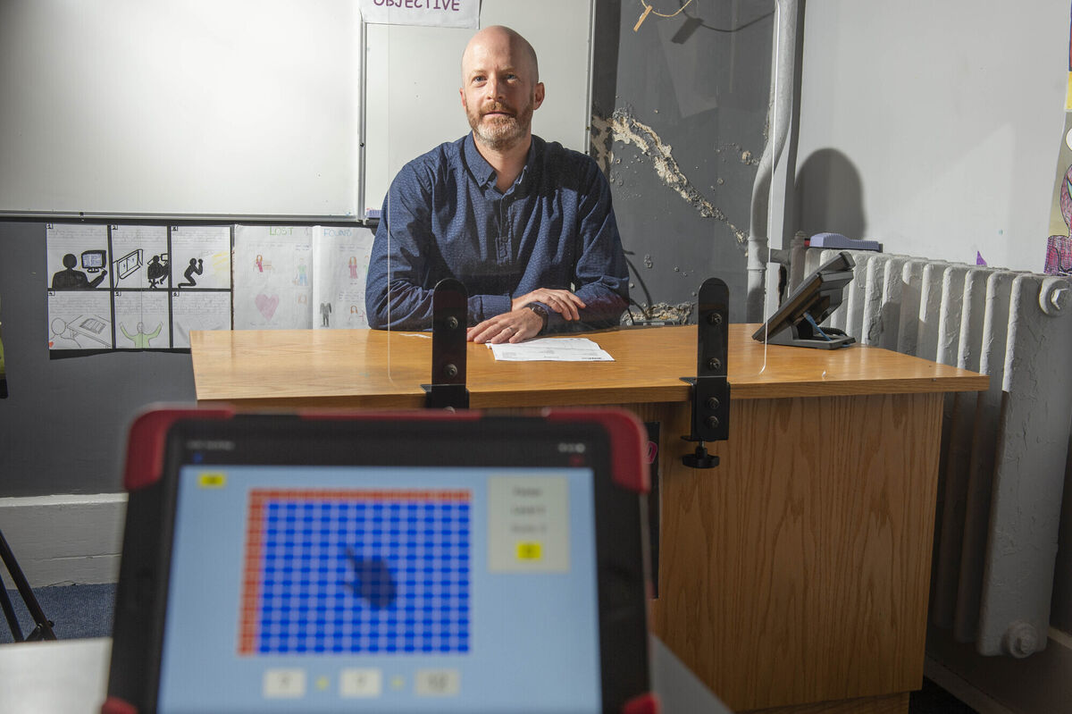 Science teacher Benjamin Cochain sits behind a perspex screen as Cork Educate Together Secondary School prepares to reopen. Picture: Michael Mac Sweeney/Provision Science teacher Benjamin Cochain sits behind a perspex screen as Cork Educate Together Secondary School prepares to reopen. Picture: Michael Mac Sweeney/Provision