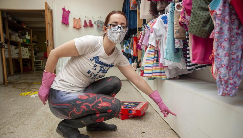 Staff member of Benson's Charity shop Leah Grobbelear points to the watermark in Bantry,  ollowing severe flooding. Picture: Daragh Mc Sweeney/Provision