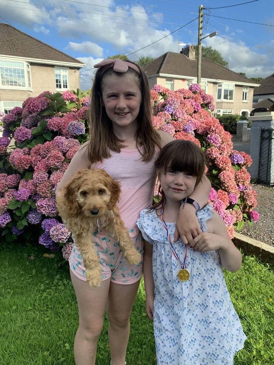 Mollie O'Donovan (10) and Rosie O'Donovan (7) with their dog Cara