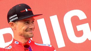 Ireland's Nicolas Roche celebrates on the podium wearing the leader's red jersey after the fourth stage of the 2019 La Vuelta cycling tour of Spain