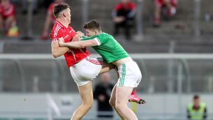 CLIFFORD CLASH: East Kerry's David Clifford grapples with Brian Leonard of St. Kieran's in an incident which saw the Kerry skipper red-carded.