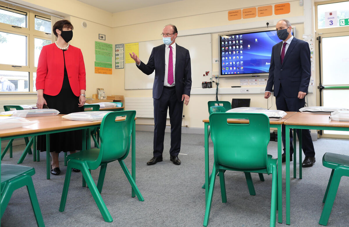 Taoiseach Micheal Martin (right) during a visit to St.Fiachra's Senior National Catholic School in Beaumont, Dublin, with Minister for Education Norma Foley and Kieran Creaner, Principal of Scoil Fiachra National School, where he was given a tour of the school and a briefing on the work undertaken to prepare the school for reopening. Picture: Julien Behal/PA Wire