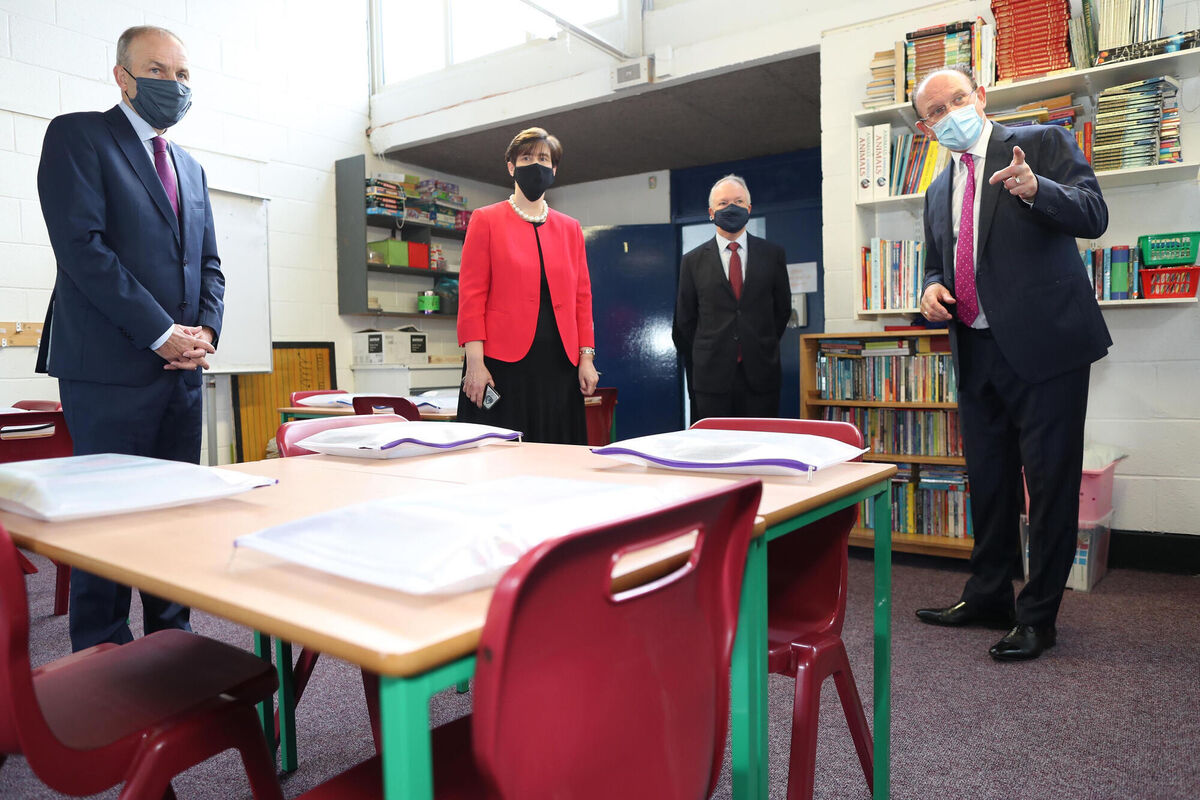 Taoiseach Micheal Martin (left) during a visit to St.Fiachra's Senior National Catholic School in Beaumont, Dublin, with Minister for Education Norma Foley, Sean Haughey and Kieran Creaner Principal of Scoil Fiachra National School, where he was given a tour of the school and a briefing on the work undertaken to prepare the school for reopening. Picture: Julien Behal/PA Wire