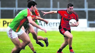 <p>Kenmare Shamrock’s Paul O’Connor is chased by Mid Kerry’s Mike Breen in their clash at Fitzgerald Stadium. 	Picture: Michelle Cooper Galvin</p>
