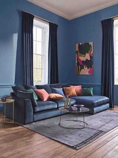 The DFS plush pillow-back right-hand facing large chaise-end sofa in dark blue velvet. 