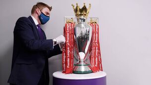 <p>The Premier League Trophy is dressed in Liverpool Red Ribbons ready for the presentation ceremony ahead of the Premier League match against Chelsea on July 22, 2020. Picture: Laurence Griffiths/Getty Images</p>