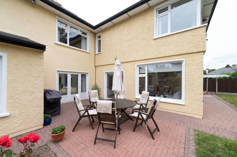 Sheltered south-facing patio between the original house 'block' and the  newer two storey extension