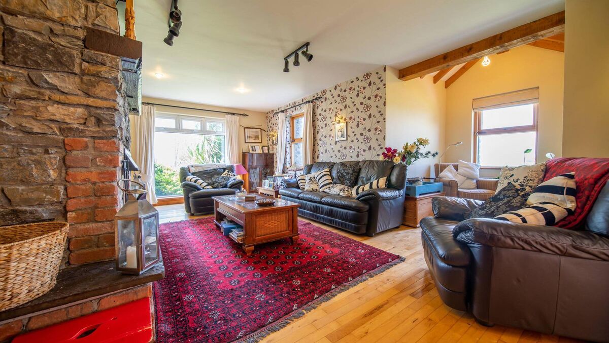 Triple aspect living room with stone and brick chimney breast