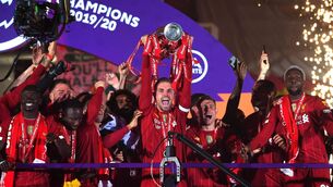 <p>Liverpool's Jordan Henderson lifts the Premier League trophy. Photo by Laurence Griffiths/Getty Images</p>