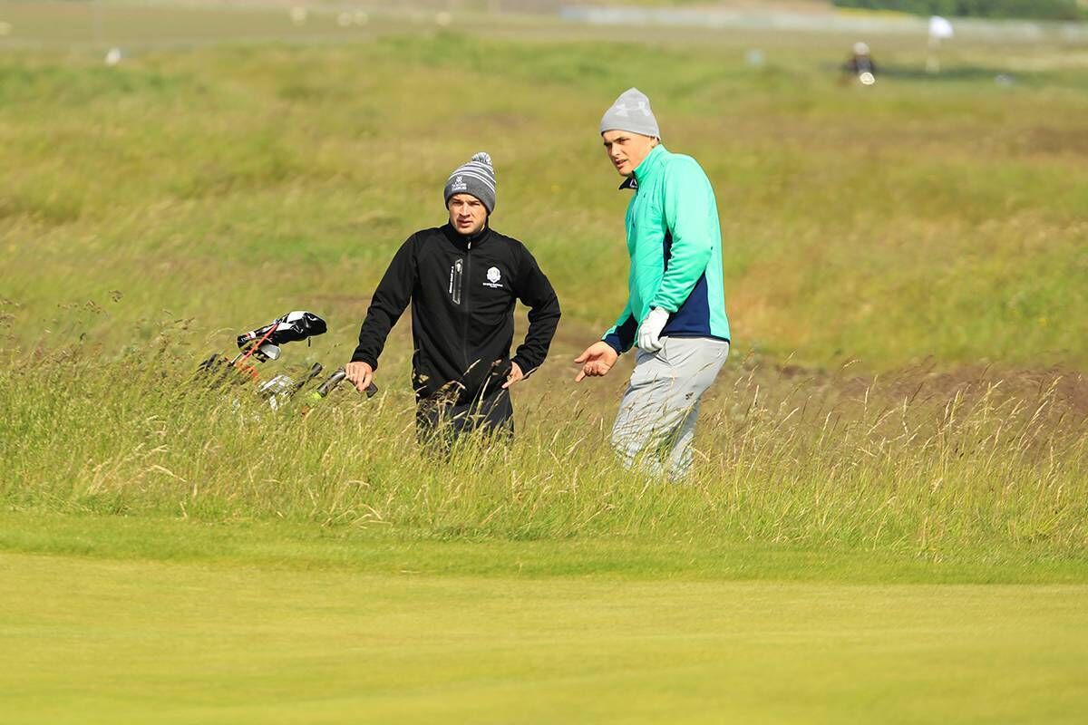 Sugrue and caddy Conor Dowling assessing their options from the rough during the first round of the Amateur Championship at Portmarnock. Picture: Niall O'Shea Sugrue and caddy Conor Dowling assessing their options from the rough during the first round of the Amateur Championship at Portmarnock. Picture: Niall O'Shea