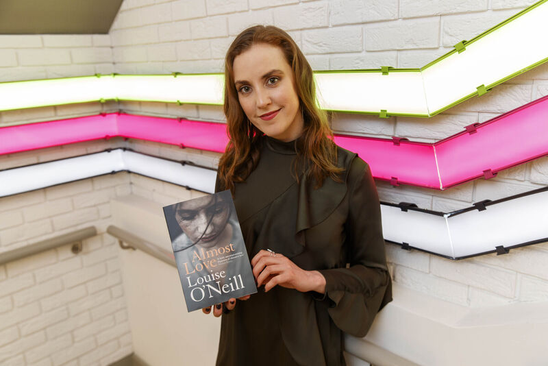 Louise O'Neill holding a copy of her book, Almost Love. Picture: Andres Poveda Louise O'Neill holding a copy of her book, Almost Love. Picture: Andres Poveda