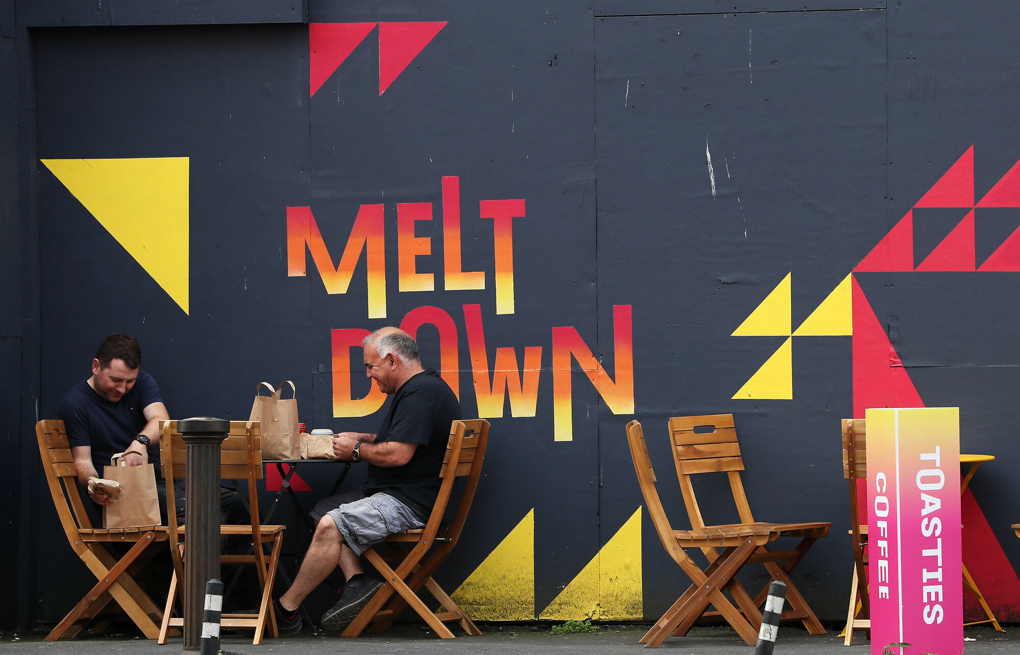 People prepare to dine in the outdoor seating area of a cafe in Dublin's city centre, as further restrictions in Dublin are imposed by the Government. Picture: Brian Lawless
