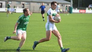 <p>HOLDING ON: Kanturk's Ian Walsh shields the ball from Aghada full back Ed Leahy in Saturday's Cork Premier IFC quarter-final at Ovens.</p>