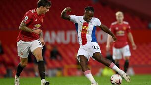 <p>ON THE BACK FOOT: Man United's Victor Lindelof (left) backtracks as Palace's Michy Batshuayi threatens. </p>