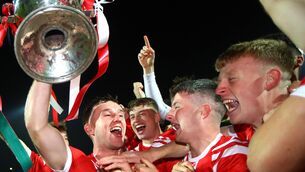 <p>The East Kerry team celebrate as captain Dan O'Donoghue holds the trophy</p>