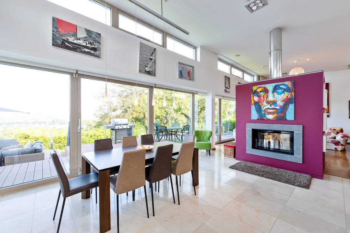 Double sided log stove divides living and dining areas