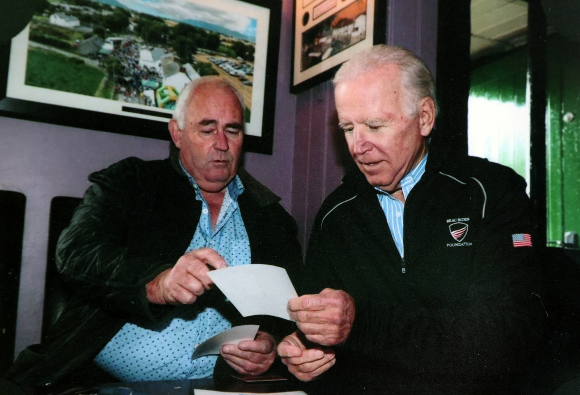 US vice-president Joe Biden looking through photos with Eamon Thorton, during his trip to Ireland. Biden has repeatedly talked up his Irish roots and his campaign will attempt to shore up support among the Irish-American population. Picture: Maxwells