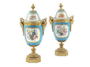 A pair of ormolu and Sevres urns at Adam's.
