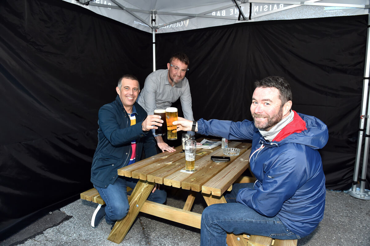 Brian O'Shea serves customers Gary O'Connell and Kevin Chaney at the new outdoor seating area at The Riverstown Inn. Picture: Eddie O'Hare