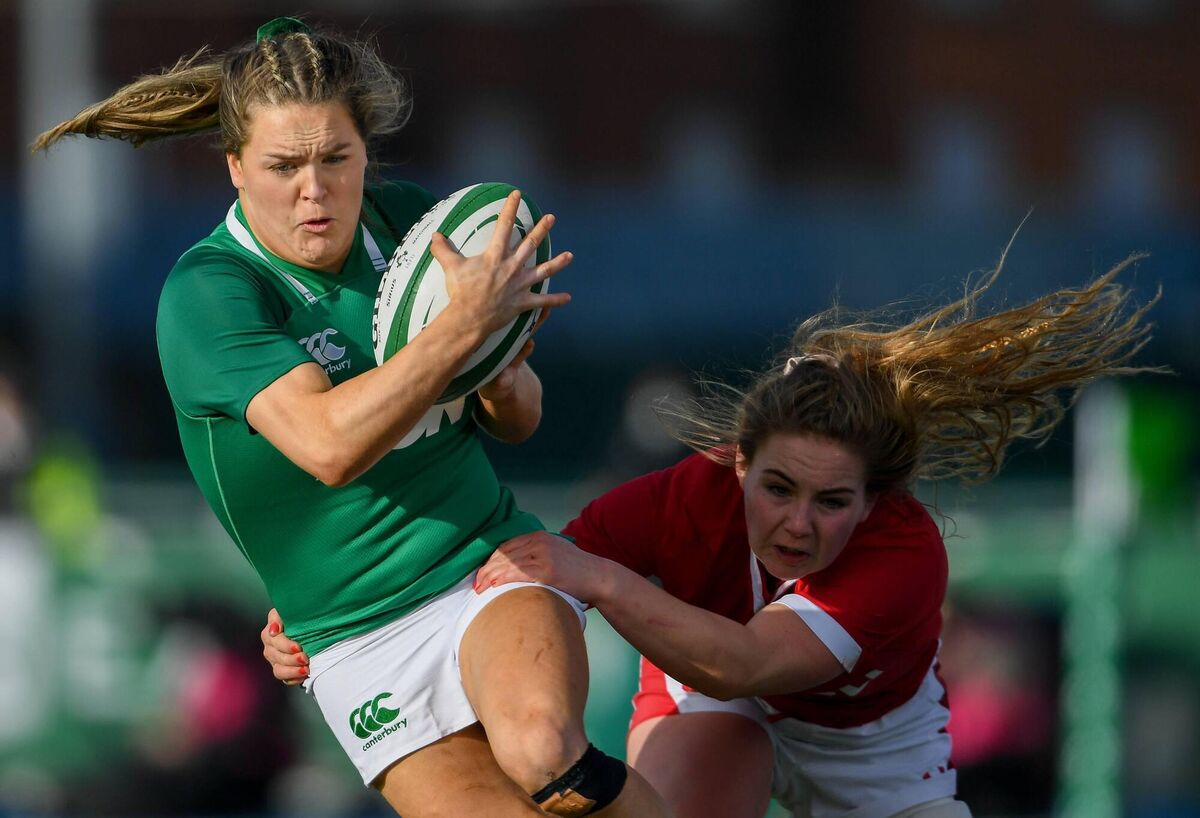 Béibhínn Parsons escapes the tackle of Manon Johnes of Wales on her way to scoring her side's first try at Energia Park in February. Photo by Ramsey Cardy/Sportsfile