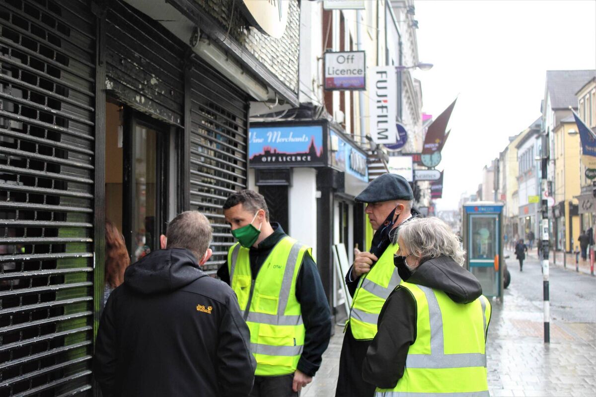 Minister Patrick O'Donavan, Cork City Council Chair Anne Doherty and Lord Mayor of Cork Joe Kavanagh speaking to business owners on Oliver Plunkett St following the floods on Tuesday. Picture: Philip Williams 