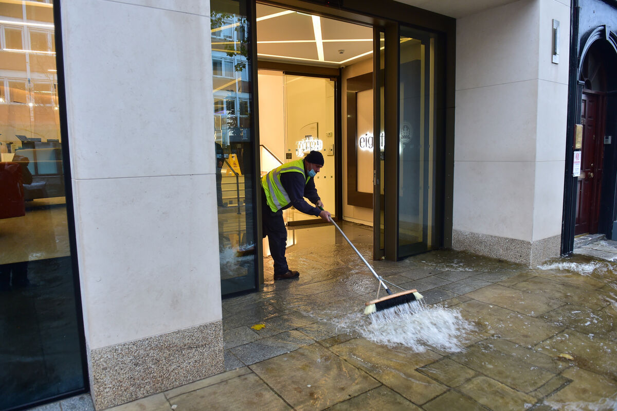 Brushing out the floodwater at 85 South Mall, Cork. Picture Dan Linehan Brushing out the floodwater at 85 South Mall, Cork. Picture Dan Linehan