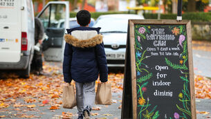 <p>A child collects packed lunch bags from a cafe in Liverpool. Picture: Peter Byrne/PA</p>