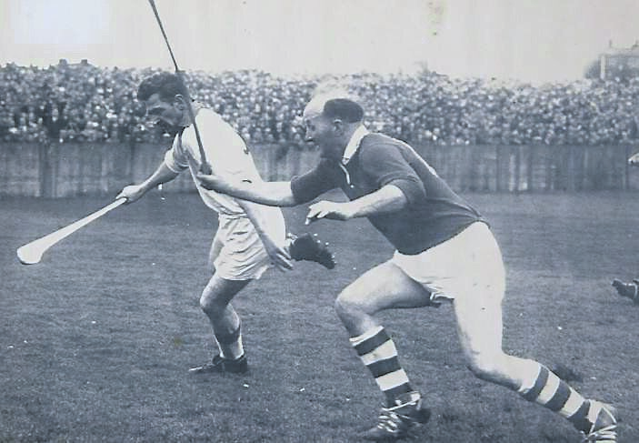 Waterford full-back Austin Flynn under pressure from Ring in a 1954 league game.