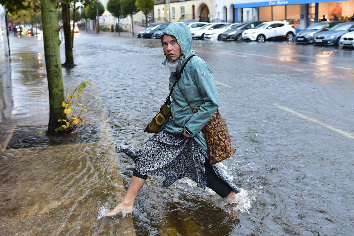  A woman making her way through the floodwater at South Terrace in Cork. Picture: Dan Linehan