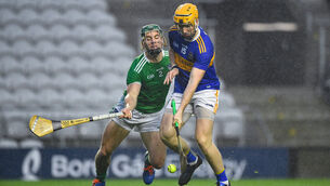 <p>Jake Morris of Tipperary scores his side's goal despite the challenge of Sean Finn. Picture: Daire Brennan/Sportsfile</p>