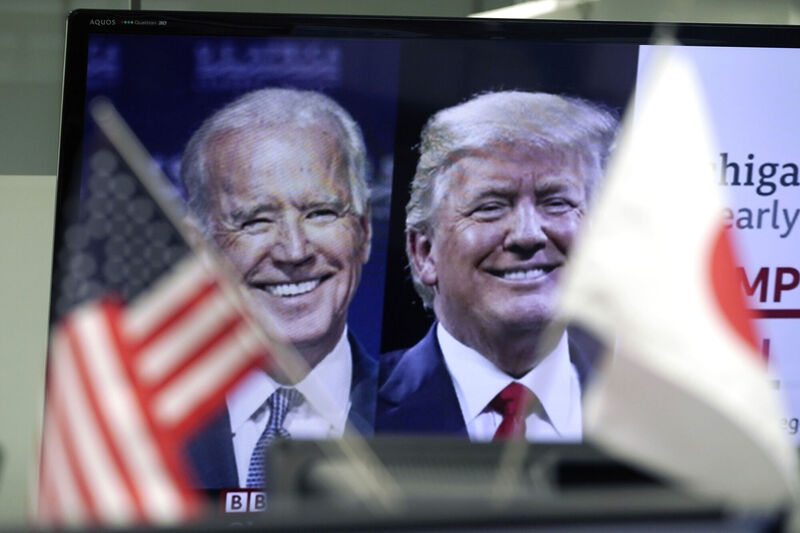 A Japanese and a U.S. flags are placed in front of a TV monitor showing a news program live broadcasting on the U.S. presidential election between President Donald Trump, right, and former Vice President Joe Biden, left, at a foreign exchange dealing company Wednesday, Nov. 4, 2020, in Tokyo. Picture: AP Photo/Eugene Hoshiko A Japanese and a U.S. flags are placed in front of a TV monitor showing a news program live broadcasting on the U.S. presidential election between President Donald Trump, right, and former Vice President Joe Biden, left, at a foreign exchange dealing company Wednesday, Nov. 4, 2020, in Tokyo. Picture: AP Photo/Eugene Hoshiko