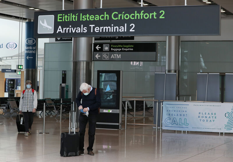 People wearing protective face masks in Terminal 2 in Dublin Airport as a requirement for people arriving in Ireland from overseas to alert the authorities where they will be self isolating has come into effect.