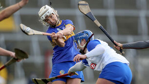 <p>Tipperary’s Nicole Walshe strikes under pressure from Claire Whyte of Waterford. Picture: INPHO/Bryan Keane</p>