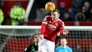 <p>Wayne Rooney heading a football during his Manchester United days (PA)</p>